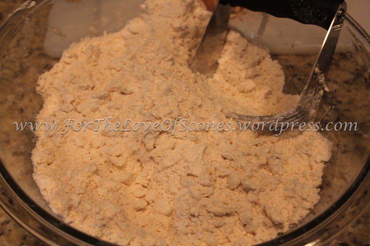 Work in the butter with a pastry blender until uniform. Some larger chunks of butter are okay.