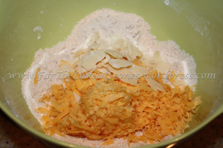 Add the cheeses to the dry ingredients.