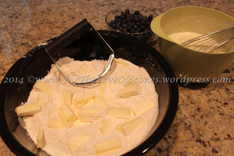 Add the cold, chopped butter to the dry ingredients and mix with a pastry blender.