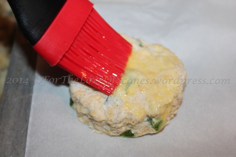 Transfer to a parchment-lined baking sheet and brush the tops of the scones with the egg glaze.